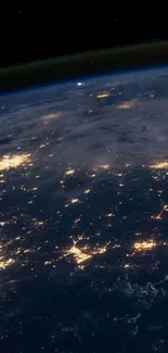 Stunning nighttime view of Earth from space, highlighting city lights.