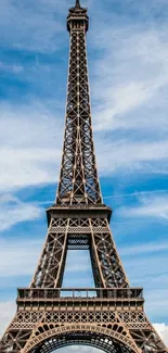 Eiffel Tower with blue sky and clouds in the background.