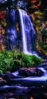 Serene forest waterfall surrounded by lush greenery and autumn foliage.