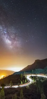 Night sky over mountains with city lights and Milky Way.