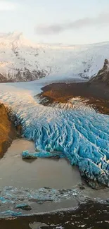 Breathtaking glacier landscape with icy blue formations and snow-capped mountains.