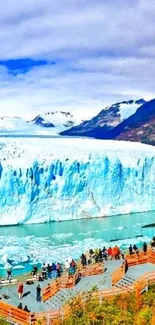 Majestic glacier against mountain backdrop in vibrant blue hues.