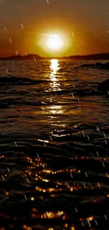 Golden sunset over calm ocean waters with vibrant reflections.