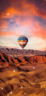 Hot air balloon over mountains at sunset