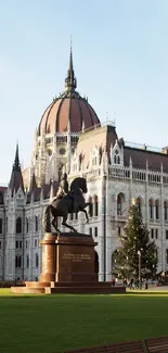 View of Hungarian Parliament with statue and trees.