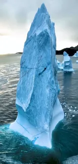 Majestic iceberg tower in serene ocean background.