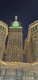 Illuminated clock tower against night sky