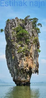 Breathtaking island rock formation in serene blue waters.