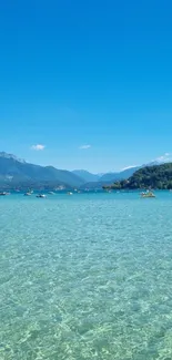 Serene lake and mountain view with clear blue sky.