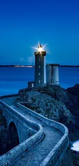 Scenic lighthouse at dusk with ocean view and stone bridge.