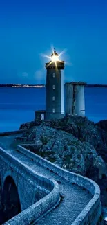 Lighthouse shining in serene night ocean scene