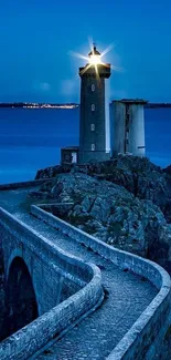 Lighthouse against a twilight blue ocean backdrop.