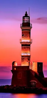 Lighthouse against a stunning sunset sky with deep purple hues.