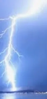 Lightning strike in a blue sky over water surface, dramatic and vibrant.