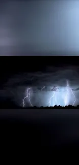 Dark sky illuminated by bright lightning bolts in a stormy night scene.