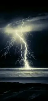 Dramatic lightning strike over dark ocean at night.