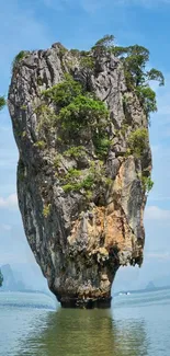 Tall limestone cliff above turquoise ocean waters and a clear blue sky.