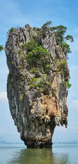 Limestone island with blue sky and lush greenery.