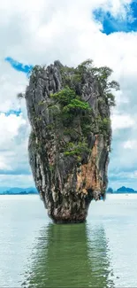 Majestic limestone rock in clear water under a vibrant blue sky.