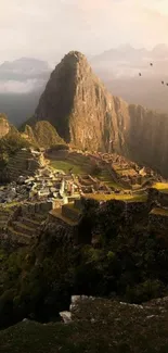 Majestic view of Machu Picchu with mountains and misty clouds on a mobile wallpaper.