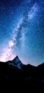 Starry night over mountain range with Milky Way in view.