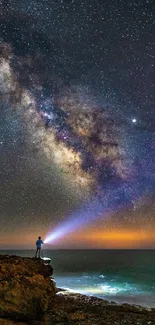 Mobile wallpaper of starry Milky Way and ocean shore at night.