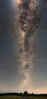 Vertical Milky Way galaxy under starry night sky with shooting star and horizon.