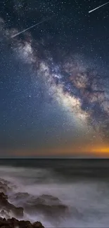 Milky Way shines over a calm ocean at night.