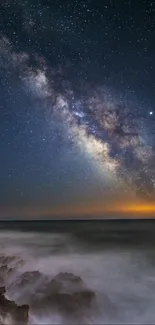 Milky Way galaxy shines brightly over ocean horizon against the night sky.