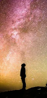 Silhouette against the Milky Way in a vibrant night sky wallpaper.