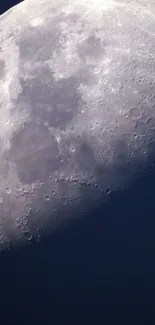 High-resolution wallpaper of the moon's surface with craters against a dark blue sky.