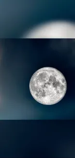 Full moon in a dark blue night sky wallpaper.