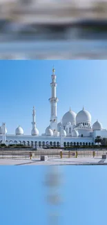 Majestic mosque under a clear blue sky, showcasing stunning Islamic architecture.