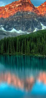 Mountain lake with forest and sunset glow on peaks.