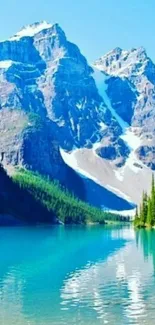 Mountain lake with blue sky and snowy peaks.