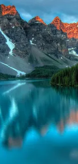 Breathtaking mountain lake at sunrise with reflections of peaks and forest.