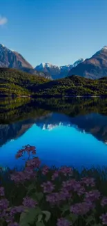 Scenic mountain lake view with blue water and snow-capped peaks.