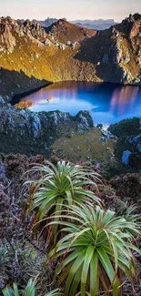 Serene mountain lake with lush greenery and rugged peaks.