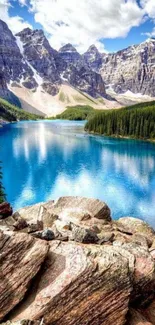 Mountain lake with blue waters and rocky foreground.