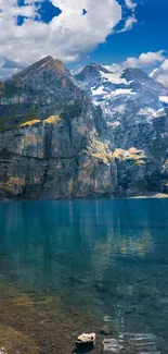 Breathtaking view of a mountain lake with clear blue water and towering peaks.