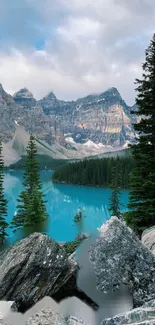 Majestic mountain lake surrounded by forest and rocky peaks under a cloudy sky.