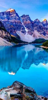 Serene mountain lake with blue water and towering peaks in a beautiful landscape.