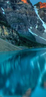 Scenic mountain lake with calm waters and towering peaks.