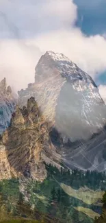 Scenic mountain landscape with green forests and cloudy peaks.