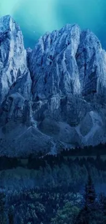 Majestic snowy mountains under a glowing blue night sky.