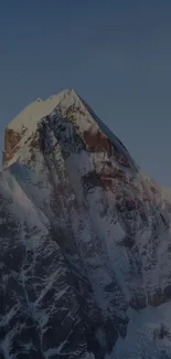 Snow-capped mountain under a blue sky, perfect for nature-themed phone wallpaper.