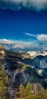 Majestic mountain range under blue sky with clouds.