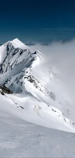 Snow-covered mountain peak piercing through clouds.