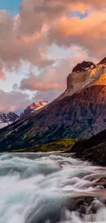 Stunning sunrise over majestic mountains with flowing waterfalls and vibrant colors.