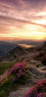 Mountain sunset with vibrant sky and rocky terrain.